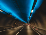 Cars moving with the appearance of speed through a tunnel.