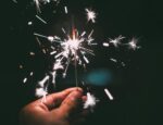 A hand holding a sparkler.