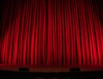 Red velvet curtains on a stage.