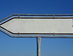 A white arrow sign pointing to the left.